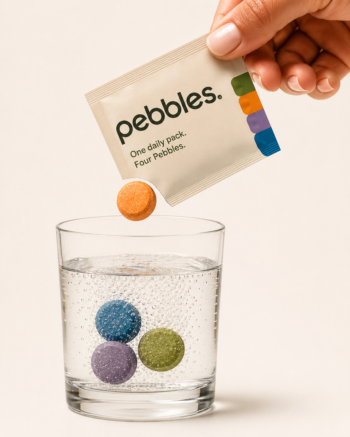 Pebbles daily pack dropping a fizz tablet into a glass of water